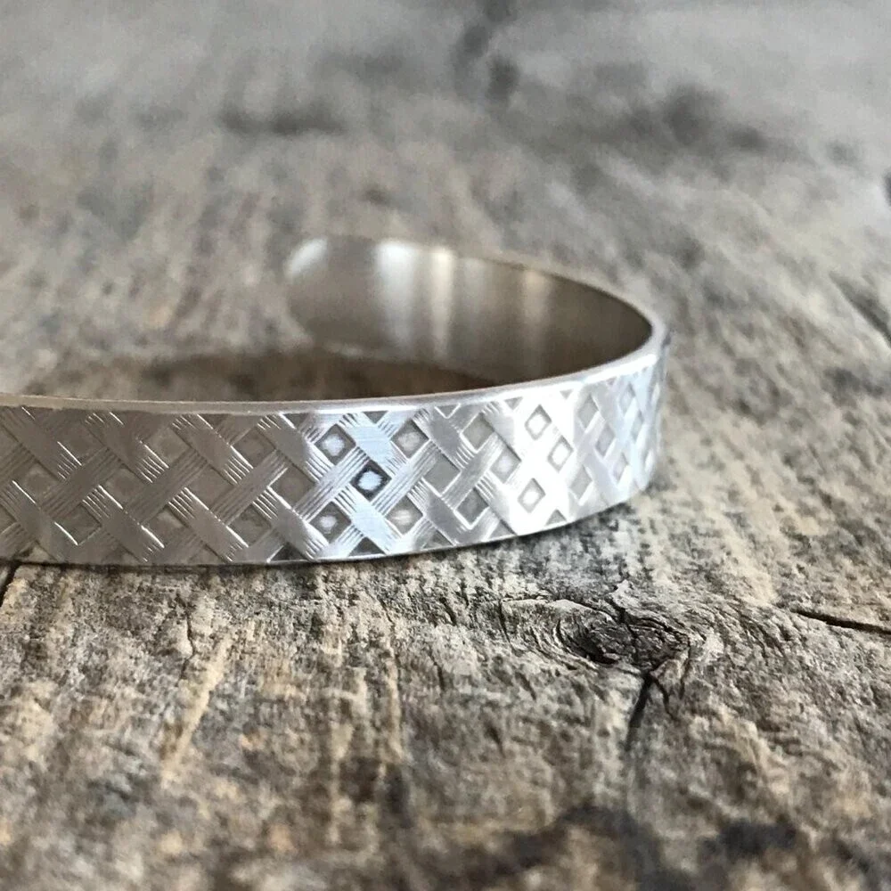 Brushed sterling silver woven tartan plaid pattern open cuff bangle bracelet.